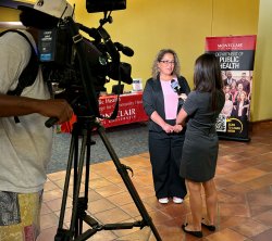 A reporter interviews Stephanie Silvera.