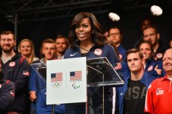 First Lady Michelle Obama participates in a basketball demonstration during the U.S. Olympic Committee 100 day countdown event to the Rio 2016 Games at Times Square. 