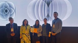 Dr. Wang with Rahul Thakkar holding the Best Paper Certificate with conference delegates