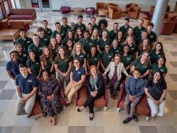 Group photo of the PSEG Institute for Sustainability Studies Green Teams from 2019. The group is seated in the atrium of the CELS building and the photographer is standing above on the stairs.