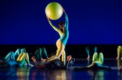 Image of dancer performing onstage with a large ball