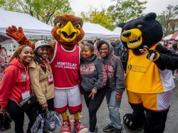 Mascots, Rocky and Deacon, taking a picture with students.