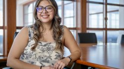 Rebeca A. Soto Avalos sits, leaning against a table.