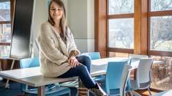 Alex Hatala sitting atop a classroom desk